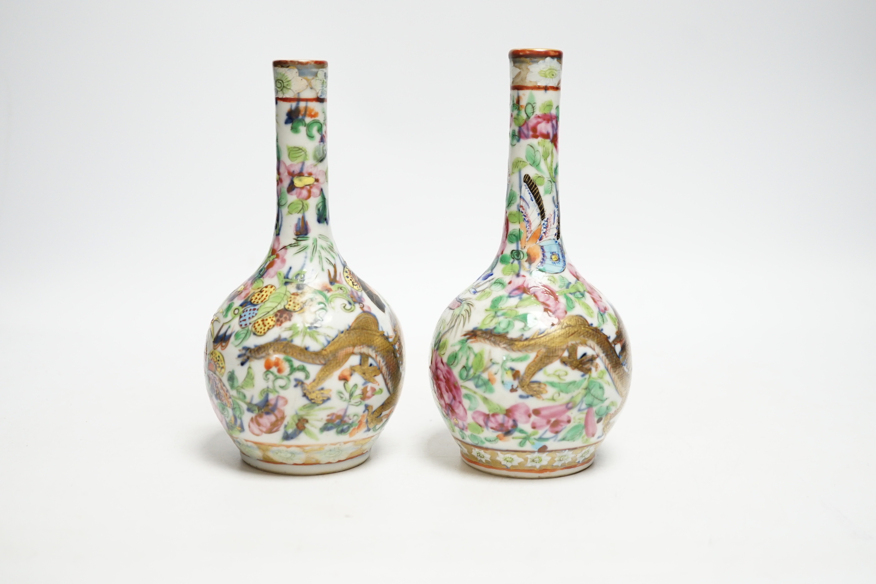 A pair of 19th century Chinese clobbered famille rose 'dragon' bottle vases, 15.5cm